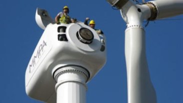 Construction workers building wind turbine